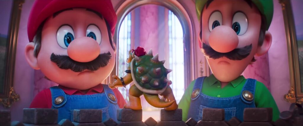 Mario en Luigi kijken verbaasd naar een miniatuur van het kasteel van Bowser in de trailer van The Super Mario Galaxy Movie